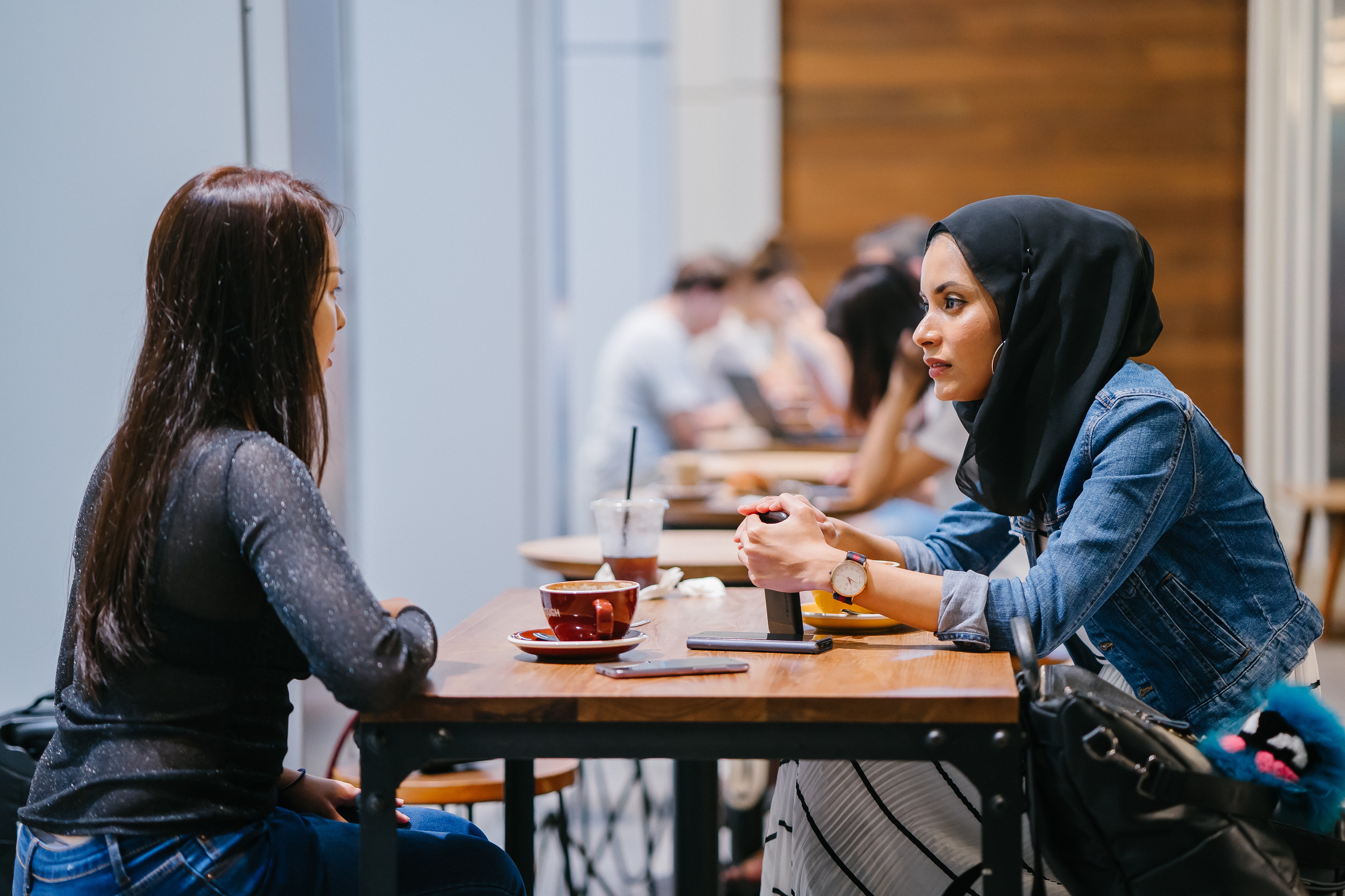 people-sitting-beside-tables-indoors-1568342